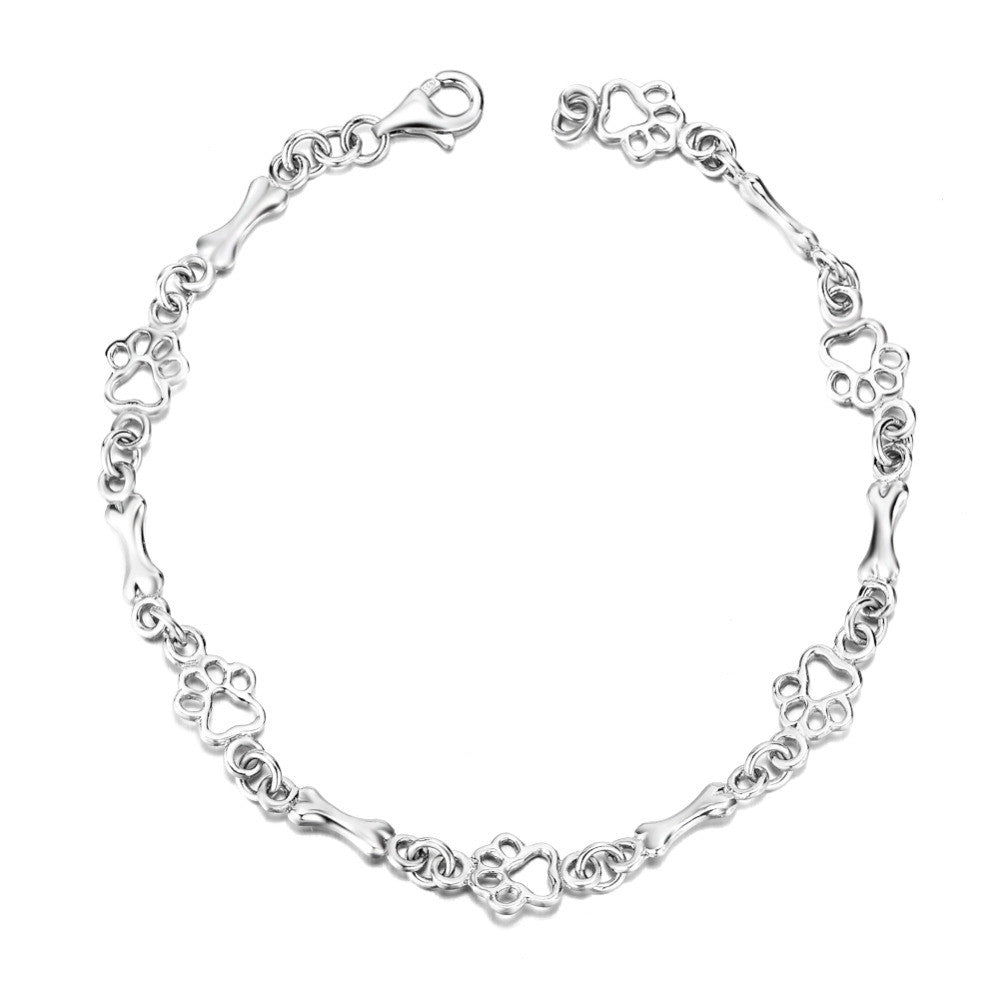 Silverarmband med tassavtryck och benmotiv
