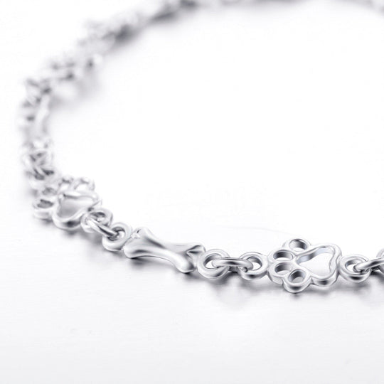 Silverarmband med tassavtryck och benmotiv