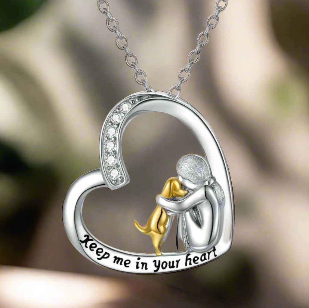 Silverhalsband med hjärthängsmycke, flicka och hund
